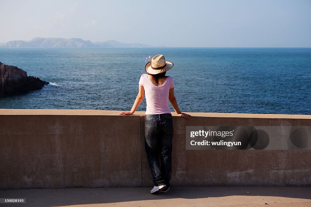 Girl facing to  blue sea