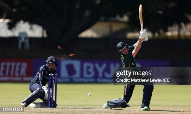 George Dockrell of Ireland is bowled by Brandon McMullen of Scotland during the ICC Men's Cricket World Cup Qualifier Zimbabwe 2023 match between...