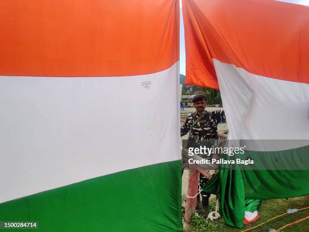 An armed soldier peeps out from behind a security curtain as part of the tight security arrangements at Second Lavender Festival on June 5, 2023 at...