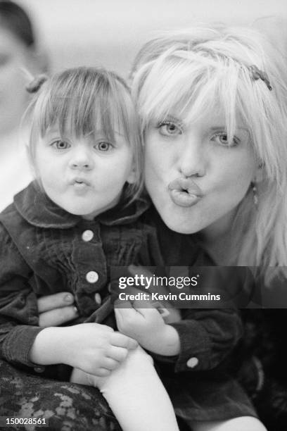 Singer-songwriter Courtney Love, of American alternative rock group Hole, backstage with her daughter Frances Bean Cobain before a concert at Rote...
