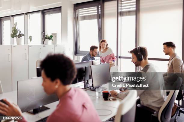 programmer in a software developing company - programmer team stock pictures, royalty-free photos & images