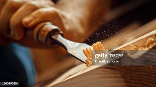 carpenter shapes wood with chisel - wood stock pictures, royalty-free photos & images