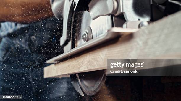 saw cutting wooden plank - sawing-machine stock pictures, royalty-free photos & images