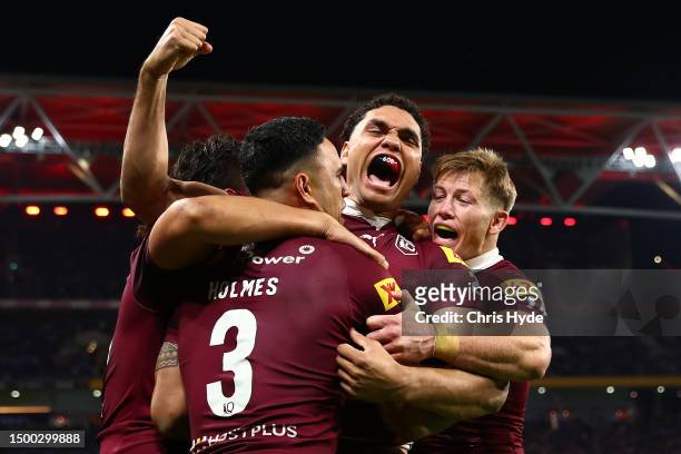 Xavier Coates of the Maroons celebrates with try-scorer Valentine Holmes during game two of the State of Origin series between the Queensland Maroons...