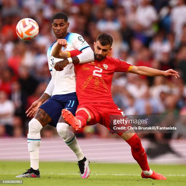 Marcus Rashford of England in action with Egzon Bejtulai of Macedonia during the UEFA EURO 2024 qualifying round group C match between England and...