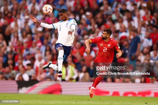 Marcus Rashford of England in action with Egzon Bejtulai of Macedonia during the UEFA EURO 2024 qualifying round group C match between England and...