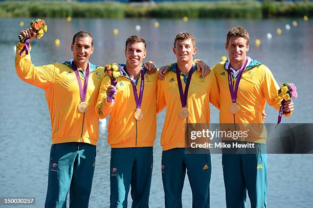 Tate Smith, Dave Smith, Murray Stewart, and Jacob Clear of Australia celebrate winning the Gold medal during the medal ceremony for the Men's Kayak...