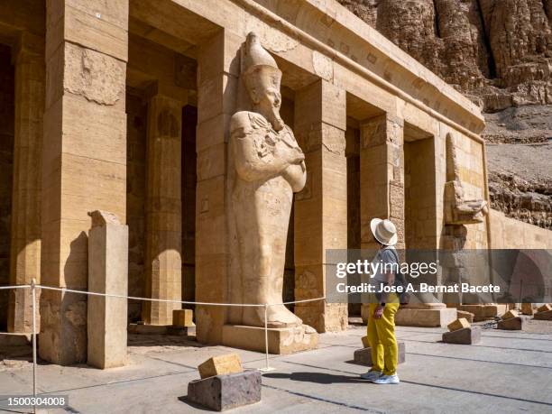 a female tourist contemplating the statues in the temple of hatshepsut at deir el bahari, egypt. - sand sculpture stock pictures, royalty-free photos & images