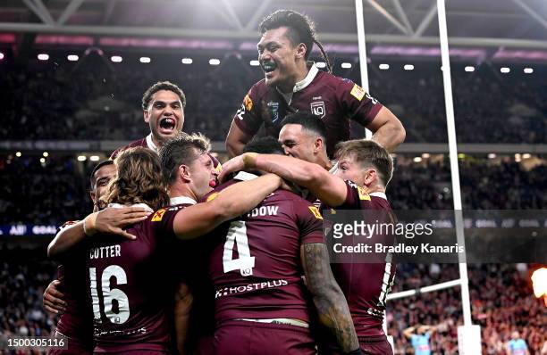 Hamiso Tabuai-Fidow of Queensland is congratulated by team mates after scoring a try during game two of the State of Origin series between the...