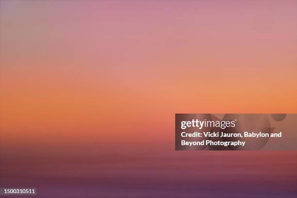 deep pinks and orange colors in sunrise sky at ocean city, new jersey - pink jersey stock-fotos und bilder