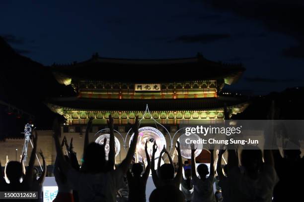 People perform yoga to mark International Day of Yoga in front of Gwanghwamun Gate on June 21, 2023 in Seoul, South Korea. The event was held as part...