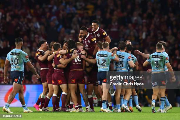 Maroons players celebrate during game two of the State of Origin series between the Queensland Maroons and the New South Wales Blues at Suncorp...