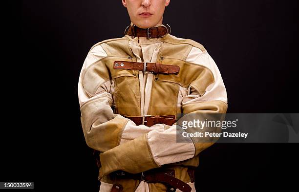 a man restrained in a straight jacket - psychopath stock pictures, royalty-free photos & images