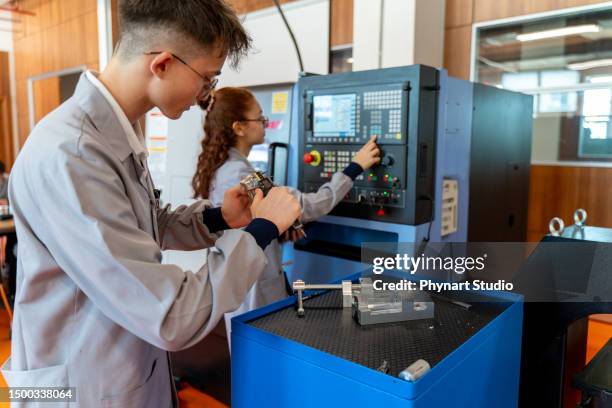 group of young people in technical vocational training with a cnc machine at school - cnc machine stock pictures, royalty-free photos & images