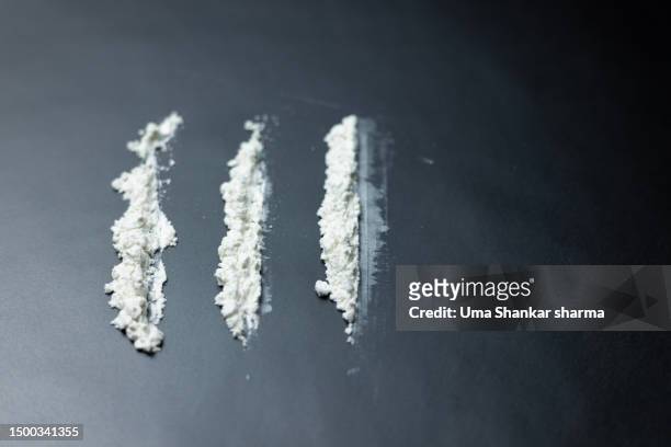 cocaine lines on black background - cocaine stock pictures, royalty-free photos & images