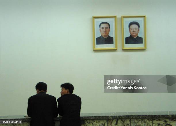 North Korean students stand in front of portraits of the late leaders Kim Il Sung and Kim Jong Il at the Grand People's Study House in Pyongyang, May...