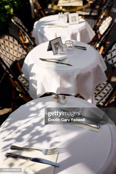 paris cafe tables in summer sunshine - bar paris stock pictures, royalty-free photos & images