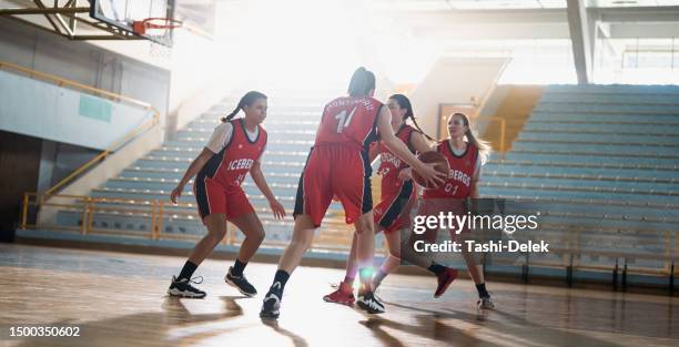 professional female basketball players training in indoor court - basketball team stock pictures, royalty-free photos & images