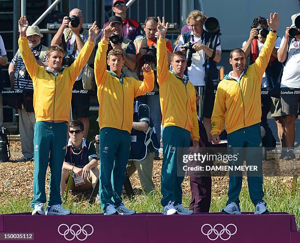 Australia's Tate Smith, Dave Smith, Murray Stewart and Jacob Clear pose on the podium before receiving their gold medals of the kayak four 1000m...