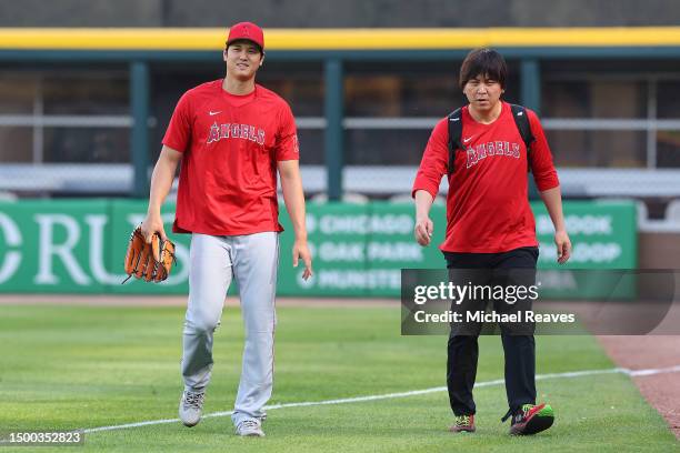 Shohei Ohtani of the Los Angeles Angels and his translator Ippei Mizuhara look on prior to the game against the Chicago White Sox at Guaranteed Rate...