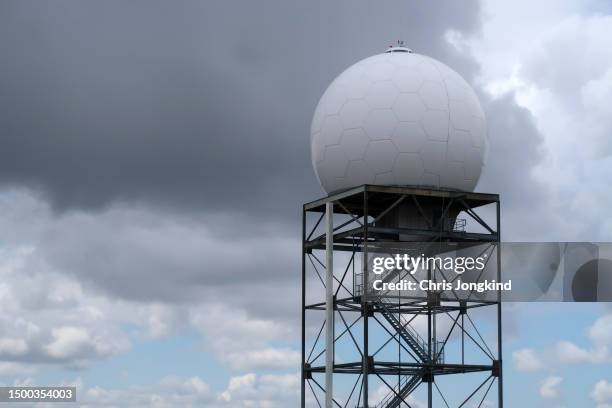 weather radar tower against partly cloudy sky - weather radar stock pictures, royalty-free photos & images