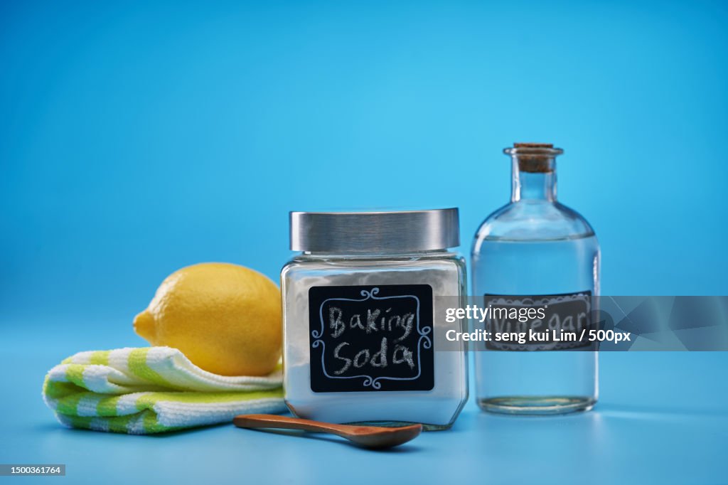 Close-up of fruits and bottle against blue background