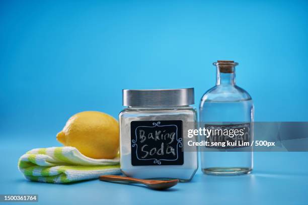close-up of fruits and bottle against blue background - laundry-detergent-containers stock pictures, royalty-free photos & images