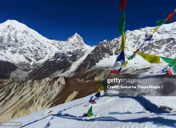 low angle view of snowcapped mountains against clear sky,nepal - nepal flag stock pictures, royalty-free photos & images