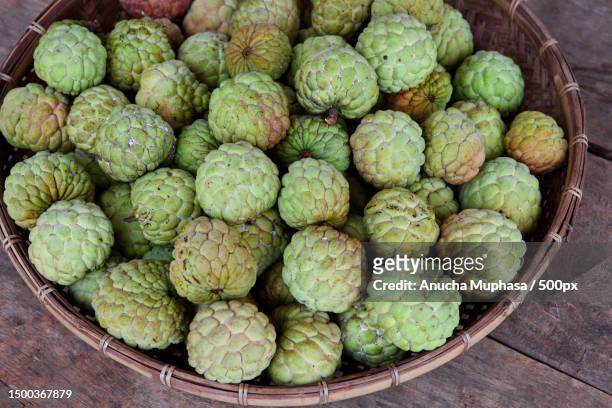 high angle view of fruits in basket on table,sa kaeo,thailand - sugar apple stock pictures, royalty-free photos & images