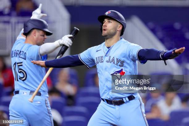 Kevin Kiermaier of the Toronto Blue Jays reacts after sliding home to score a run against the Miami Marlins during the second inning at loanDepot...