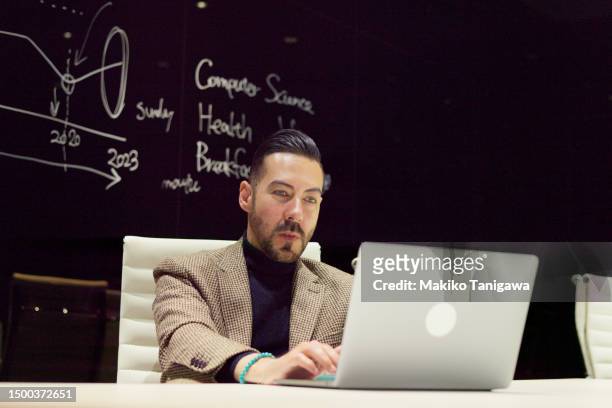 businessman having an online meeting in a conference room in office. - makiko tanigawa stock-fotos und bilder