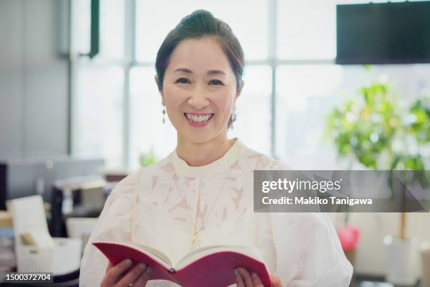 portrait of a beautiful businesswoman. - 50 year old japanese woman stock pictures, royalty-free photos & images