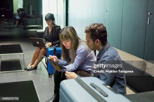 people waiting for boarding in an airport lounge. - makiko tanigawa stock-fotos und bilder