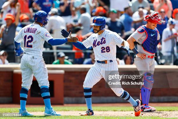 Tommy Pham of the New York Mets is congratulated Francisco Lindor after hitting a home run against the St. Louis Cardinals during a game at Citi...