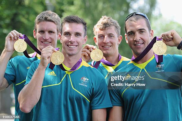 Murray Stewart, Dave Smith, Jacob Clear and Tate Smith of Australia hold up their Gold medals after the Men's Kayak Four 1000m Canoe Sprint at Eton...