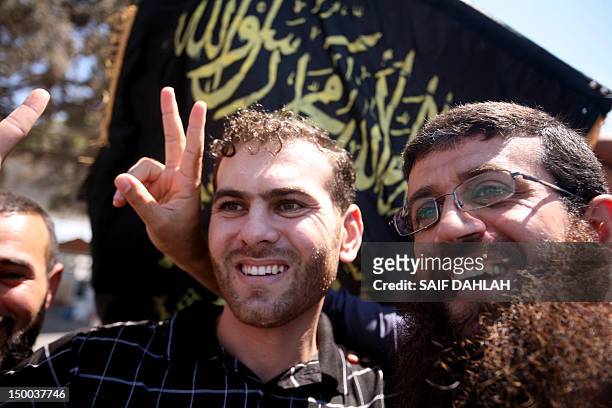 Local Islamic Jihad leader Bilal Diab poses with former prisoner Khader Adnan after crossing the Jalama checkpoint near the West Bank city of Jenin...