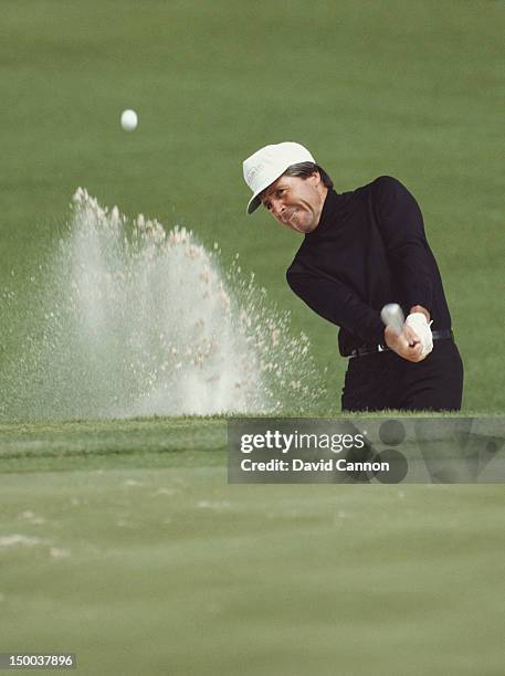 Gary Player of South Africa chips out of the sand bunker on 12th April 1984 during the US Masters Golf Tournament at the Augusta National Golf Club...