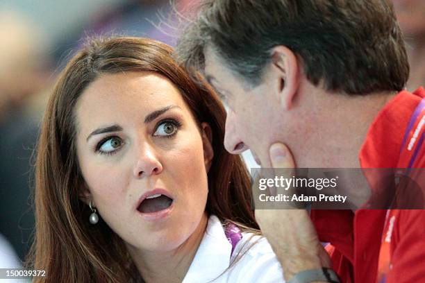 Catherine, Duchess of Cambridge and official team GB ambassador Robin Cousins watch the Women's Teams Synchronised Swimming Technical Routine on Day...