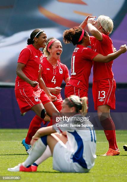 Candace Chapman, Carmelina Moscato, Desiree Scott, and Sophie Schmidt of Canada celebrate after defeating Camille Abily of France to win the women's...