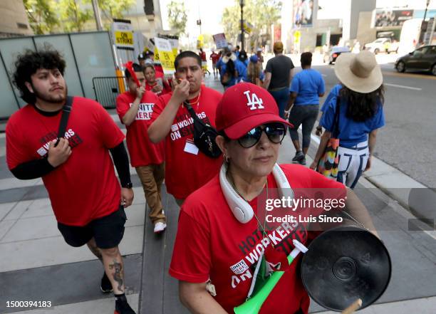 Los Angeles, CA - Striking members of Unite Here Local 11 hotel workers walk a picket line outside the JW Marriott and Ritz-Carlton hotels in...