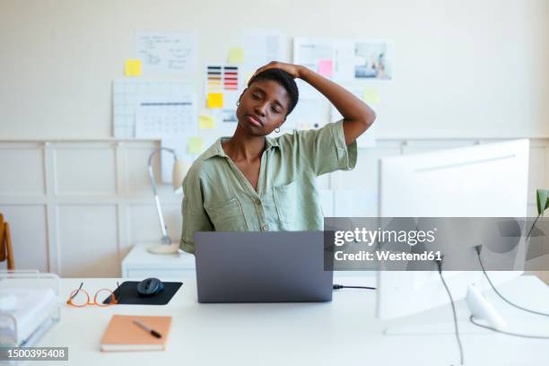 tired freelancer stretching neck at desk - neck stretch stock pictures, royalty-free photos & images