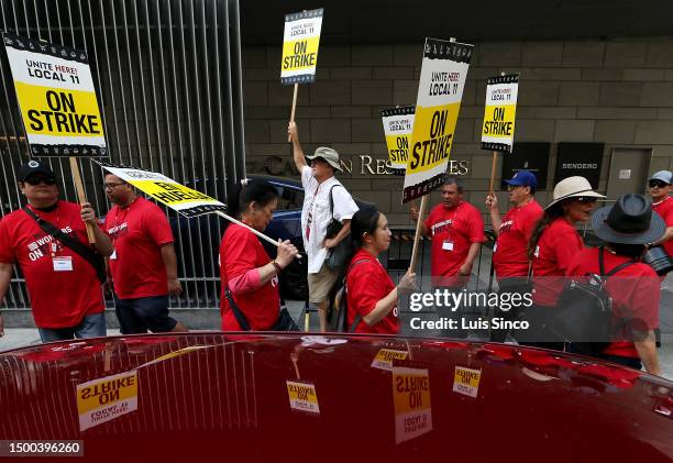 Los Angeles, CA - Striking members of the Unite Here Local 11 hotel workers union picket outside of the JW Marriott Hotel in downtown Los Angeles on...