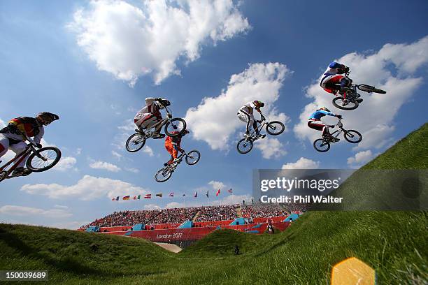 Riders clear the jump during the Men's BMX Cycling Quarter Finals on Day 13 of the London 2012 Olympic Games at BMX Track on August 9, 2012 in...
