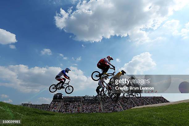 Riders clear a jump during the Men's BMX Cycling Quarter Finals on Day 13 of the London 2012 Olympic Games at BMX Track on August 9, 2012 in London,...