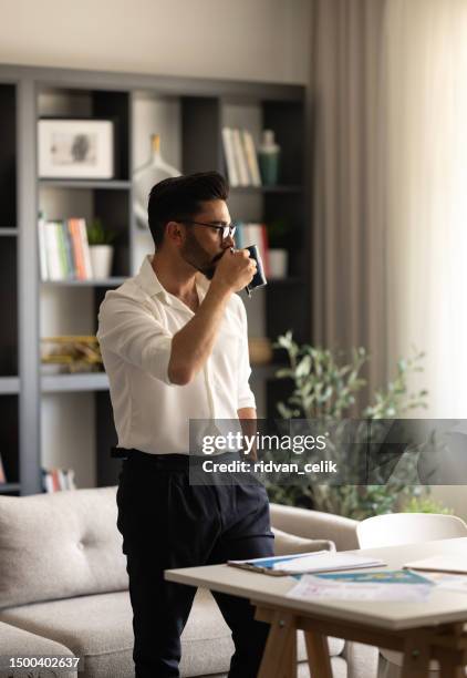 thoughtful man enjoying a relaxing coffee - enjoying coffee cafe morning light stock pictures, royalty-free photos & images