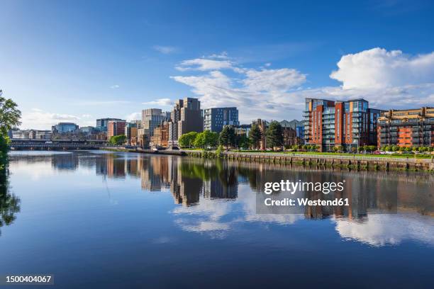 uk, scotland, glasgow, buildings reflecting in clyde river - glasgow scotland clyde stock pictures, royalty-free photos & images