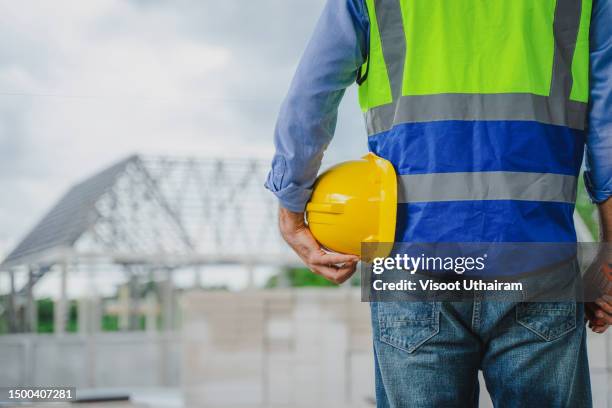 engineer working at construction site or house under construction. - herbouwen stockfoto's en -beelden