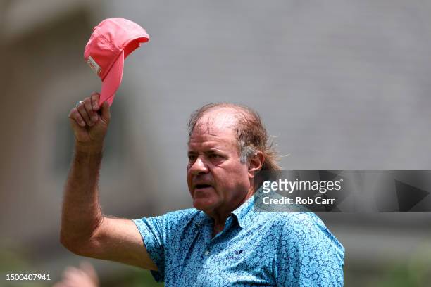 Commentator Chris Berman waves to the gallery after teeing off during a practice round prior to the Travelers Championship at TPC River Highlands on...