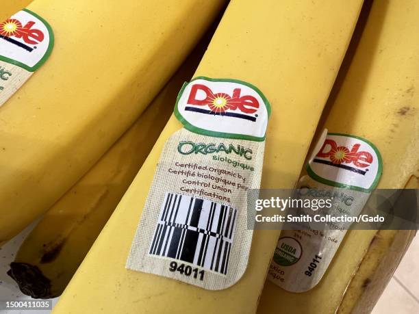 Close up of ripe bananas with Dole and USDA Organic labels, promoting certified organic products and a visit to the plantation, found in a grocery...