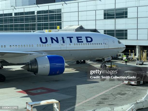 United Airlines jetliner parked at airport tarmac, featuring Star Alliance logo and various text markings, San Francisco International Airport, San...